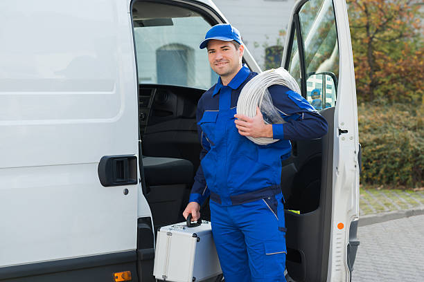 Plumber in blue uniform with equipment
